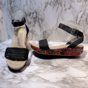 Woven black sandal with pink patterned wedge.